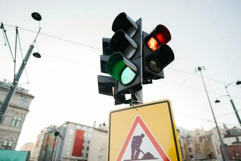 Temporary traffic control lights and triangle building site traffic sign Fotos de archivo