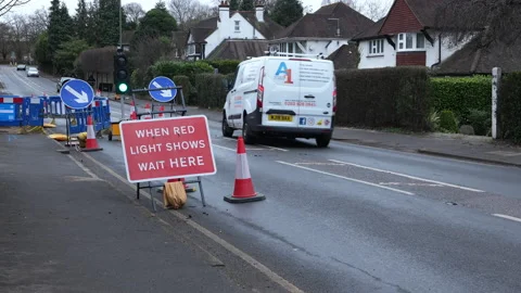 Temporary traffic lights on busy road. Left lane closed. Stock Footage 233174697