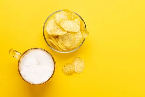 A tempting snack of beer and chips Stock Photos