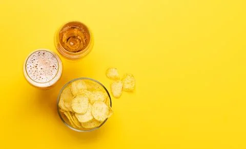 A tempting snack of beer and chips Stock Photos
