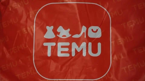 Temu orange bag package with logo on it, center frame close up Stock Footage 247754526