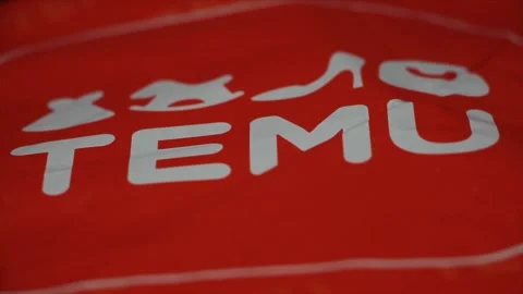 Temu orange bag package with logo on it, angle straight close up on it Stock Footage 247754557