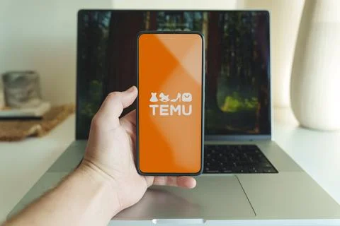 Temu shopping application logo in front of laptop. High quality photo Stock Photos