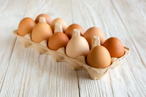 Ten brown eggs Stock Photos