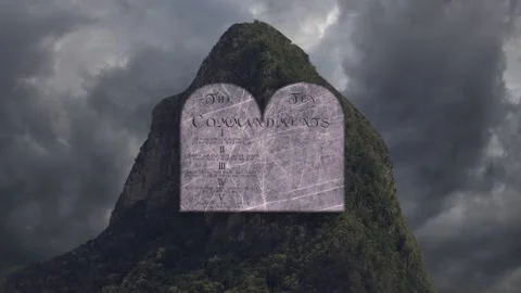 A Ten commandments being written on stone in stormy valley Stock Footage 155230575