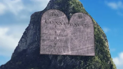 A Ten commandments being written on stone in sunny valley pan up Stock Footage 155231816