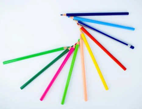 Ten different colored pencil crayons making a beautiful circle shaped pattern Stock Photos