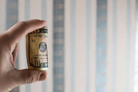 Ten dollars in hand Stock Photos