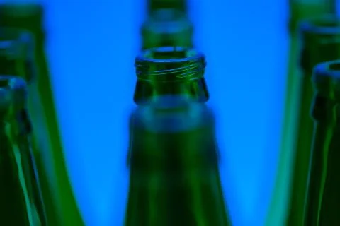 Ten Green Bottles in Three Rows Shot with Blue Light. Stock Photos