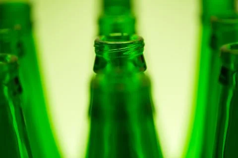 Ten Green Bottles in Three Rows Shot with Green Light. Stock Photos