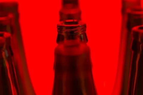 Ten Green Bottles in Three Rows Shot With Red Light. Stock Photos