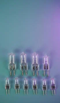 Ten halogen capsule lamps on a gradient background. Stock Photos