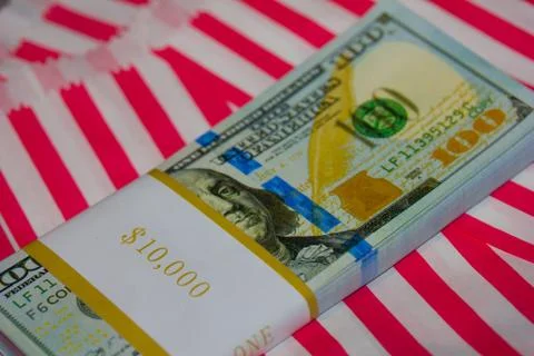 Ten Thousand Dollars Stack in hundreds on Red &amp; White Striped Background Stock Photos