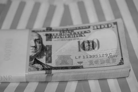 Ten Thousand Dollars Stack in hundreds on Red &amp; White Striped Background (B&amp;W Stock Photos