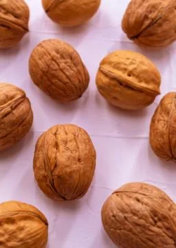 Ten walnuts lie on a white background close-up Stock Photos