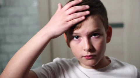 Ten year old boy combing his hair standing in front of a mirror looking at the c Stock Footage 306355550