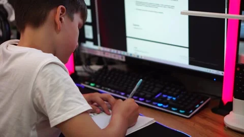 Ten year old boy diligently doing written homework sitting at table. close up Video stock 307121785