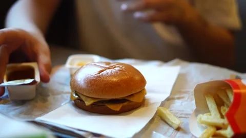 A ten-year-old boy eats fried potatoes. going to a cafe. Stock Footage 248378724