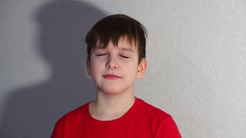 Ten year old boy looking at camera and smiling a little. close-up portrait Stock Footage 297451241