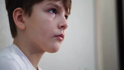 Ten year old boy playing console on TV. Face turned to the side Video stock 297553246