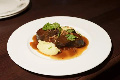 Tender beef cheeks with mashed potatoes and rich brown gravy. Stock Photos