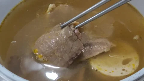 Tender Beef Slice in Rich Broth Held by Chopsticks Stock Footage 291701954