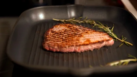 Tender beef steak grilling on a griddle Stock Footage 105106984