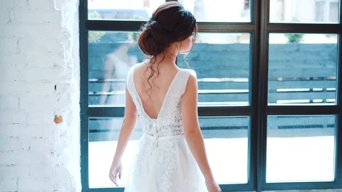 Tender bride, attractive dark-haired girl in white adorable dress with deep Stock Footage 100287660