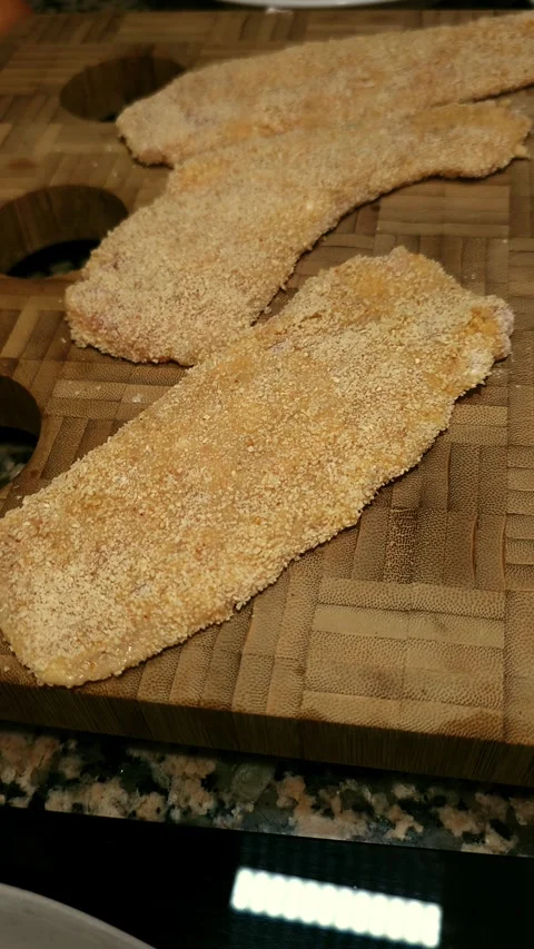 Tender chicken fillets ready to fry while resting on cutting board. Stock Footage 344857694