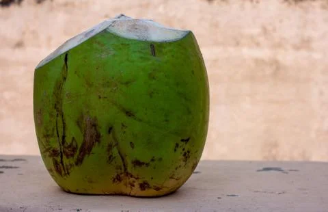 Tender coconut sliced and ready for consumption. Natural healthy beverage. Stock Photos