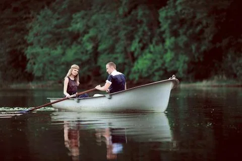 Tender couple boating on river Stock Photos