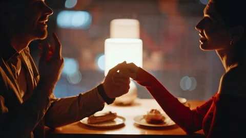 Tender couple holding hands at romantic night date in restaurant closeup. Stock Footage 340110367