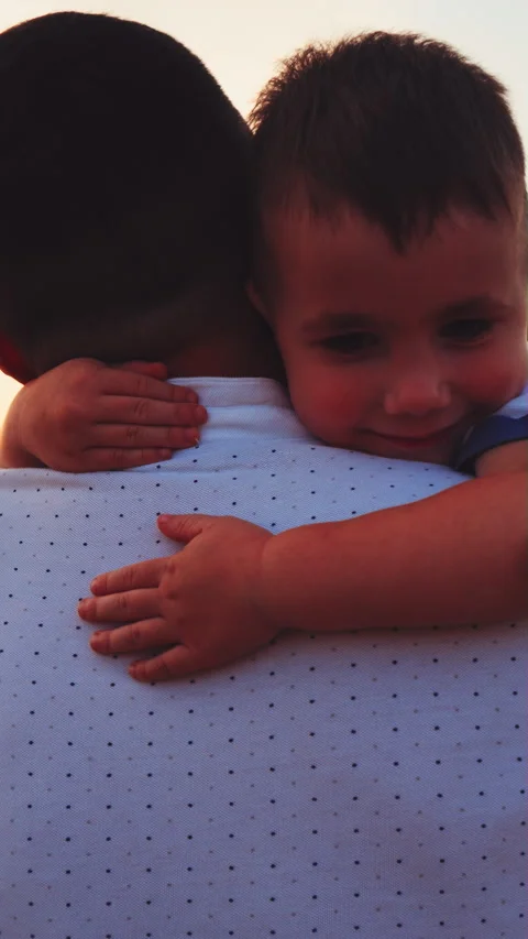 Tender hug between father and son at sunset Stock Footage 345715964