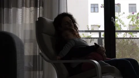 The tender image of a little girl while sleeping in the arms of her mother Stock Footage 130539787