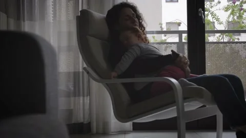 The tender image of a little girl while sleeping in the arms of her mother Stock Footage 130540064