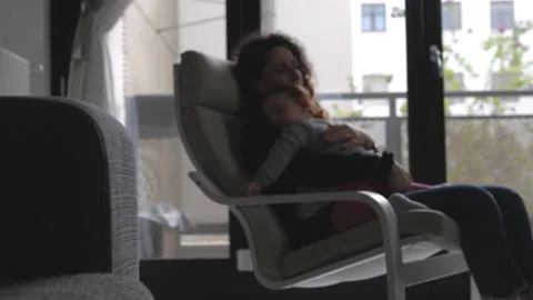 The tender image of a little girl while sleeping in the arms of her mother Stock Footage 130540281