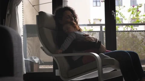 The tender image of a little girl while sleeping in the arms of her mother Stock Footage 130540661