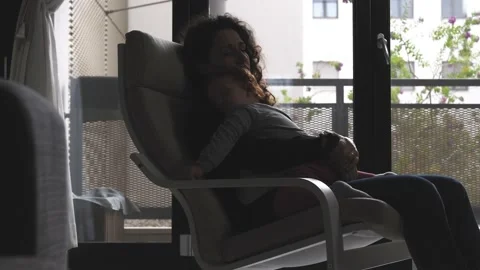 The tender image of a little girl while sleeping in the arms of her mother Stock Footage 130540991