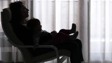The tender image of a little girl while sleeping in the arms of her mother Stock Footage 130541624