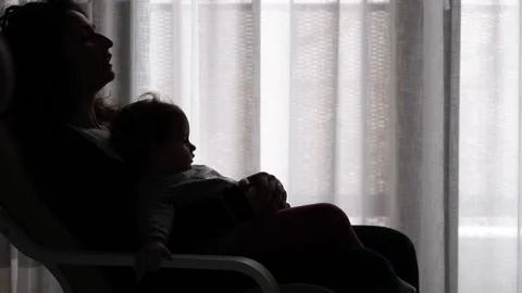 The tender image of a little girl while sleeping in the arms of her mother Stock Footage 130542132