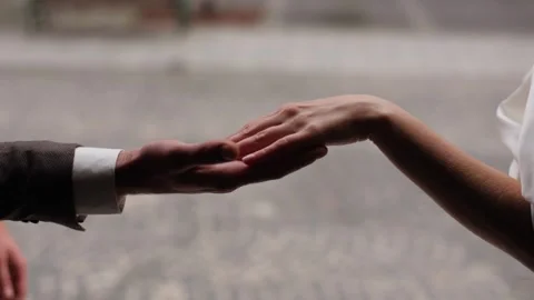 Tender intimate moment between bride and groom, brides hand delicately traces Stock Footage 286272279