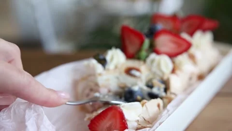 Tender meringue roll with blueberries and strawberries close up Stock Footage 142492466
