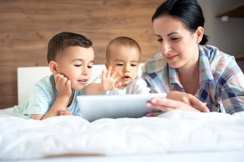 Tender mom spending quality time with her children Stock Photos