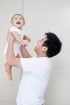 Tender moment between Chinese father and son Stock Photos