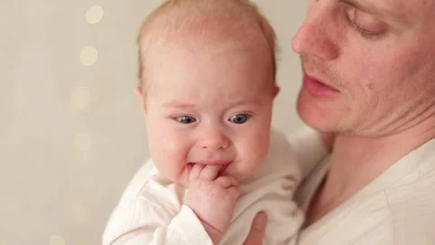 Tender moment between father and baby, close-up of loving embrace and gentle Stock Footage 340586914