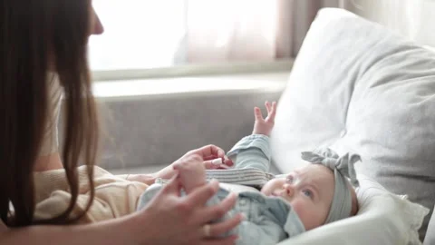 Tender moment between mother and baby, gentle touch and loving gaze Stock Footage 340589948
