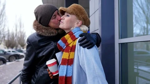 Tender moment captured as a man affectionately kissing a woman's cheek while Stock-Footage 303876929