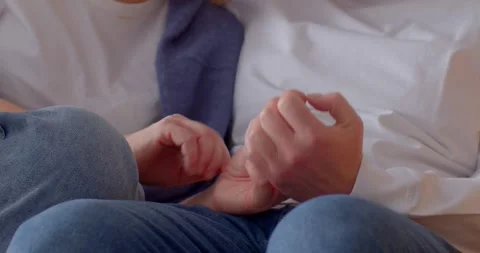 Tender Moments: Couples Interlocking Hands in Cozy Atmosphere Video stock 322903774
