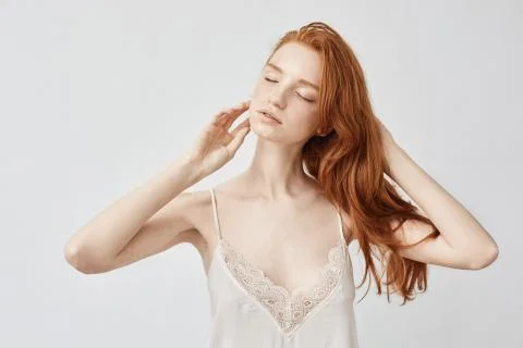 Tender nude redhead model posing with closed eyes Photos