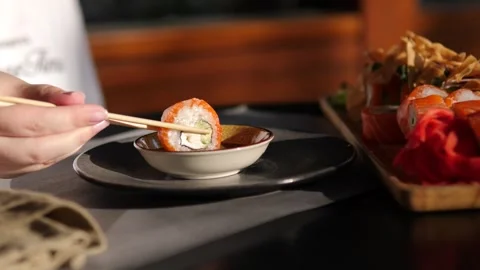 A tender roll of red fish is dipped in soy sauce Stock Footage 282717309